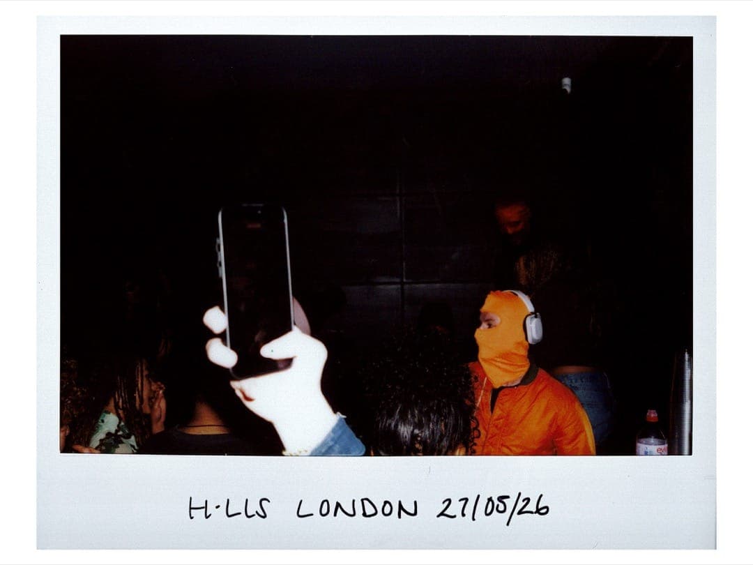 Benny in an orange balaclava and headphones in the crowd at the H.LLS London party